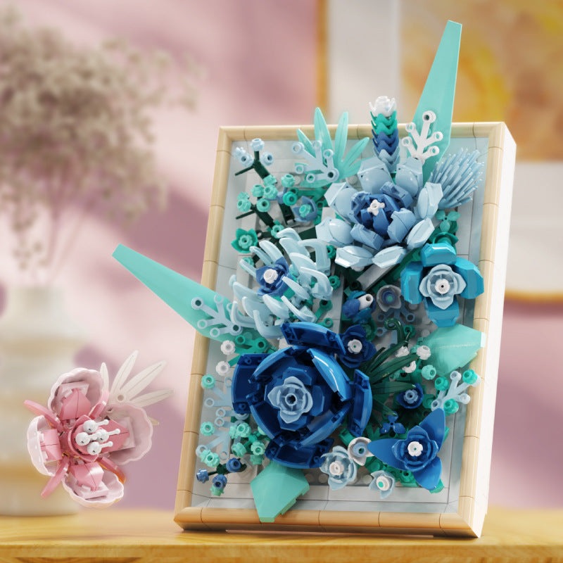 Vast Glaze Flower Picture Frame – MJI 13060 botanical building set – blue frame on a wooden shelf with a pink flower and vase, soft pink backdrop