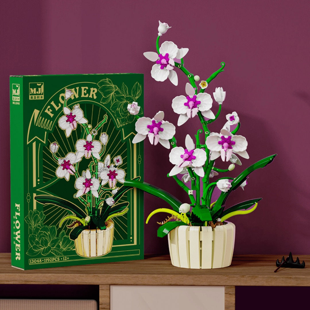 Orchid – MJI 13048 botanical building set – the orchid built in white/magenta beside its retail box, burgundy backdrop